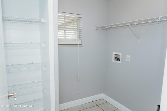 laundry area featuring washer hookup and light tile patterned floors