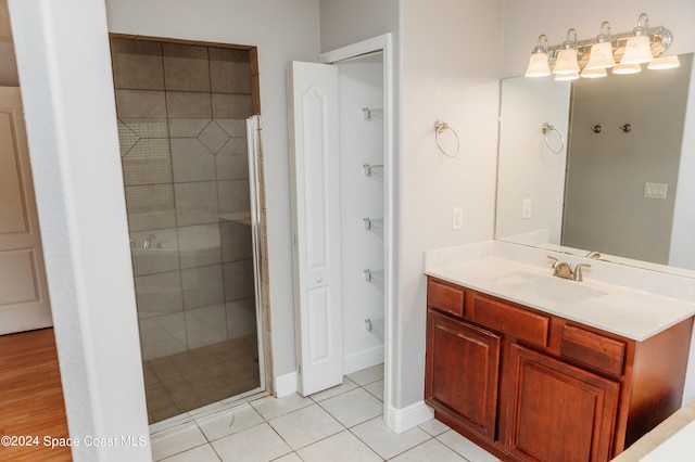 bathroom with vanity, tile patterned flooring, and a shower with door