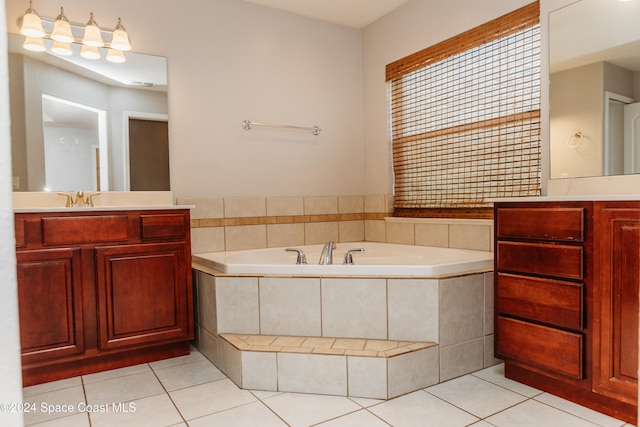 bathroom with vanity, tile patterned floors, and tiled tub