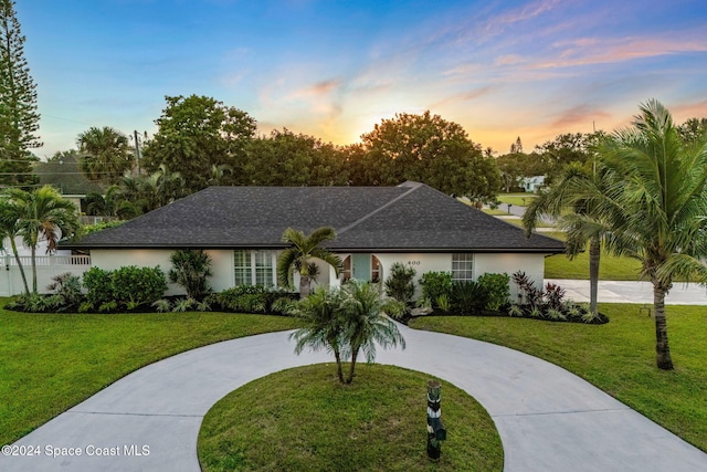 single story home with a lawn