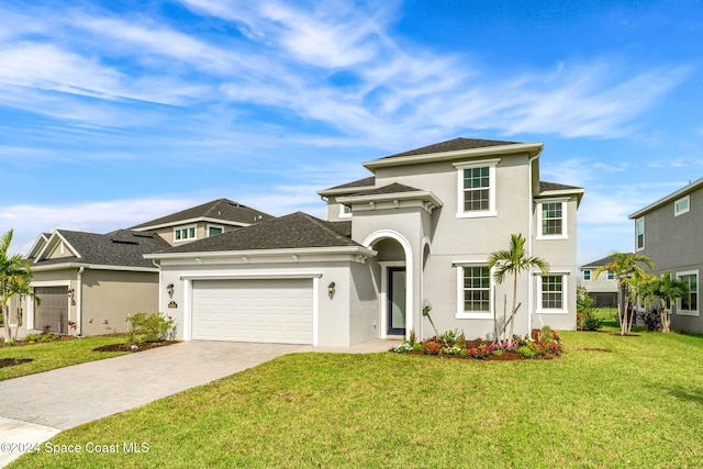 view of front of home with a front lawn and a garage