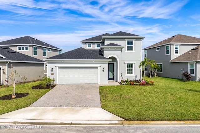 view of front property with a front lawn and a garage