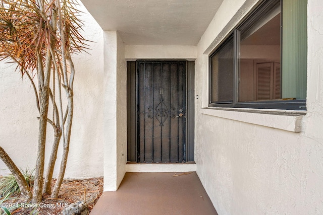 5807 N Atlantic Ave Unit 411, Cape Canaveral, FL 32920 - view of exterior entry featuring stucco siding