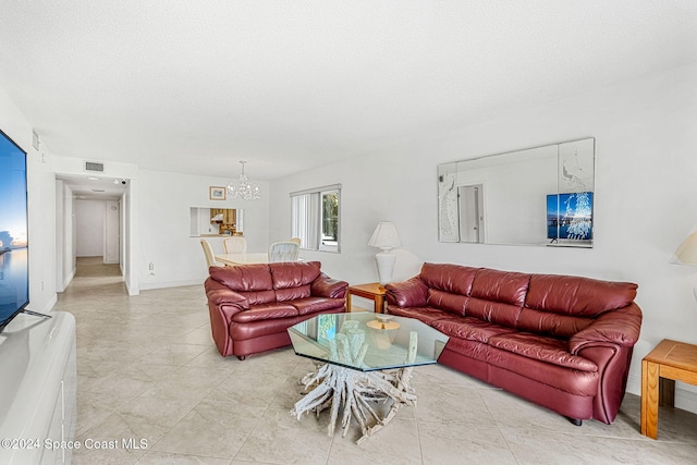 5807 N Atlantic Ave Unit 411, Cape Canaveral, FL 32920 - living area with a notable chandelier, light tile patterned floors, and visible vents