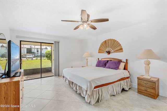 tiled bedroom with ceiling fan, access to outside, and a textured ceiling