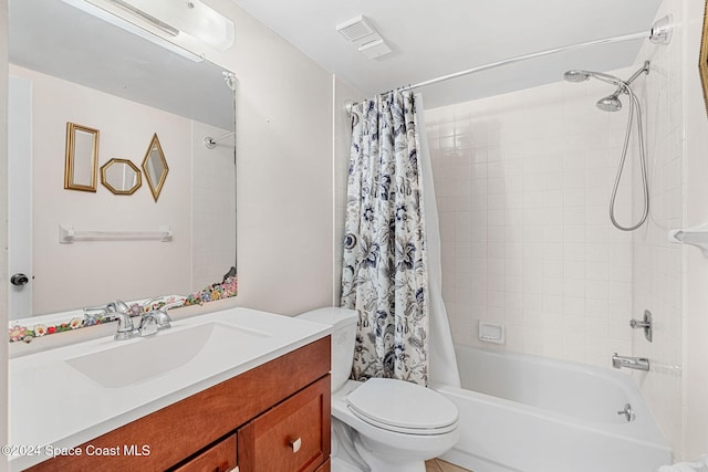 full bathroom featuring vanity, shower / bath combo with shower curtain, and toilet