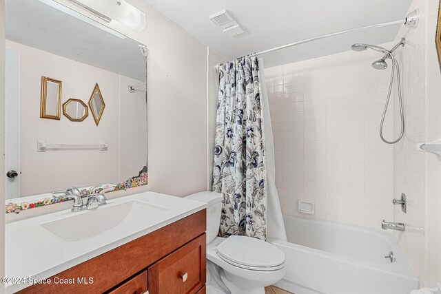 5807 N Atlantic Ave Unit 411, Cape Canaveral, FL 32920 - bathroom with vanity, shower / bath combo, toilet, and visible vents