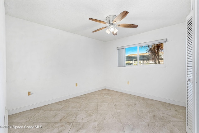 unfurnished bedroom featuring a textured ceiling and ceiling fan