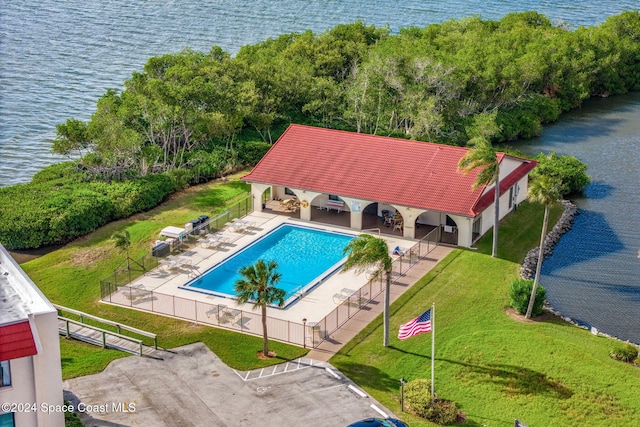 5807 N Atlantic Ave Unit 411, Cape Canaveral, FL 32920 - pool with fence, a water view, a yard, and a patio area