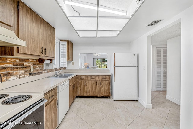 kitchen featuring white appliances, backsplash, sink, and exhaust hood