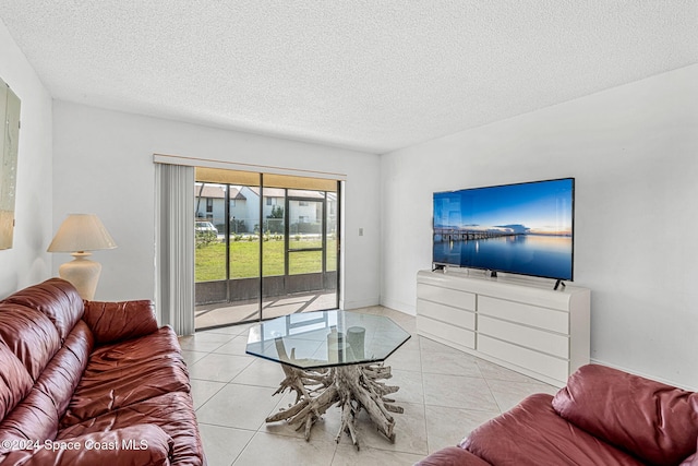 tiled living room featuring a textured ceiling