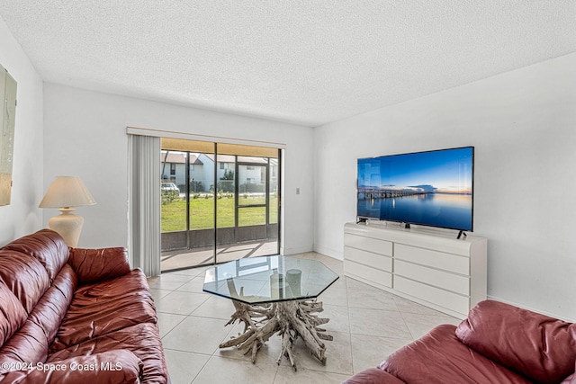 5807 N Atlantic Ave Unit 411, Cape Canaveral, FL 32920 - living room featuring tile patterned flooring and a textured ceiling