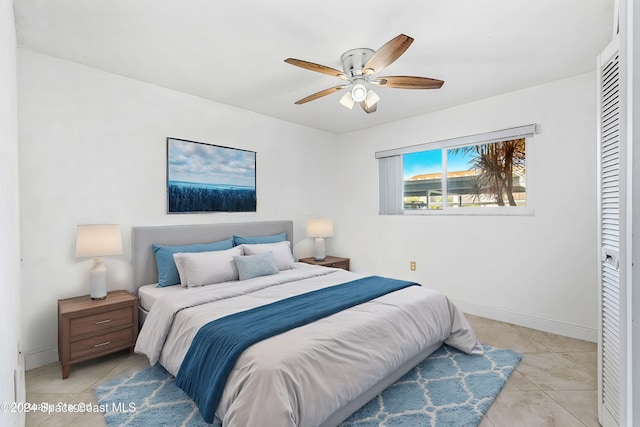 tiled bedroom with a closet and ceiling fan