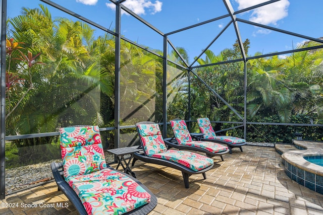 view of patio featuring glass enclosure