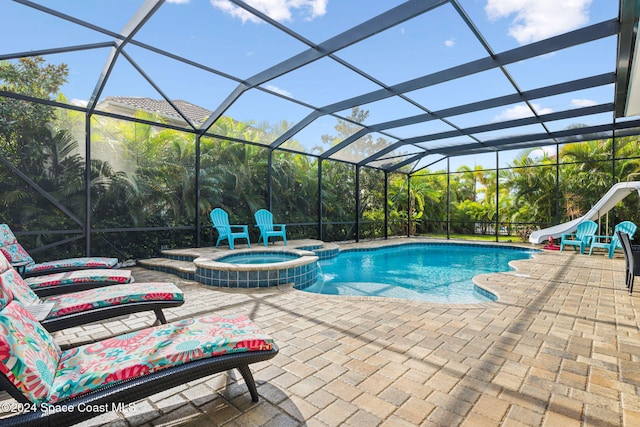 view of pool with a patio, a water slide, a lanai, and an in ground hot tub