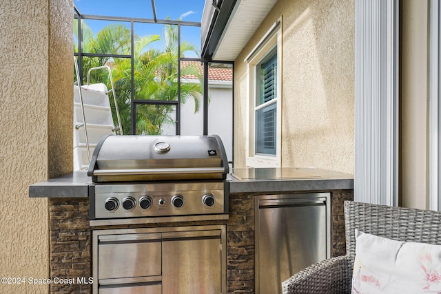 view of patio / terrace featuring a grill and a lanai