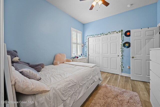 bedroom with a closet, ceiling fan, and light wood-type flooring