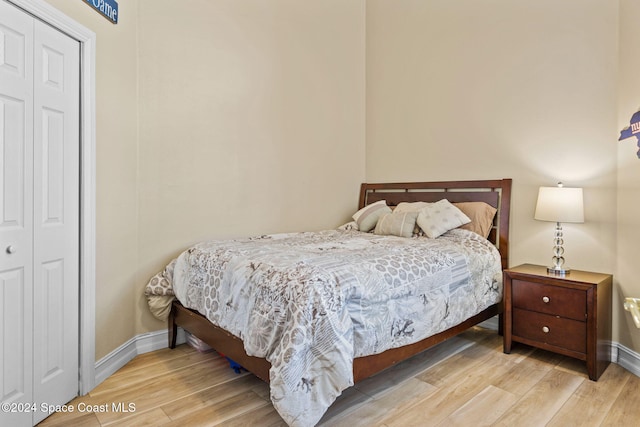 bedroom featuring a closet and light wood-type flooring