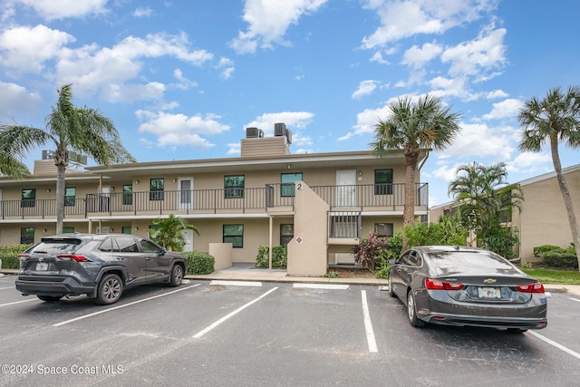 201 International Dr Unit 221, Cape Canaveral, FL 32920 - view of building exterior with uncovered parking