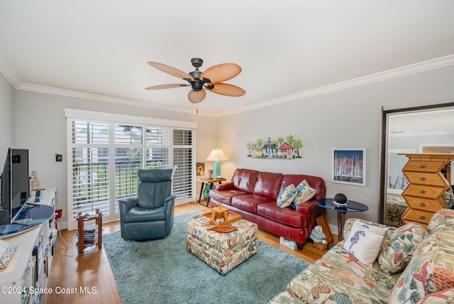 living room with hardwood / wood-style flooring, ceiling fan, and ornamental molding