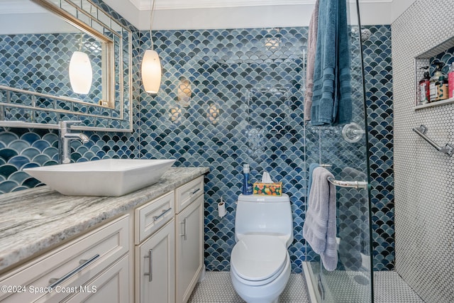 bathroom featuring vanity, toilet, crown molding, and tile walls