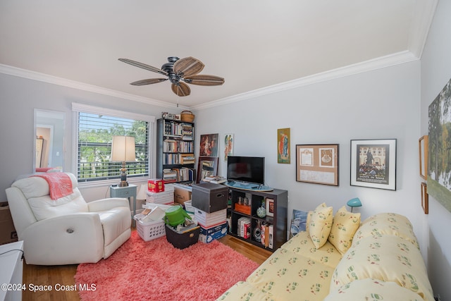 living room featuring hardwood / wood-style floors, ceiling fan, and crown molding