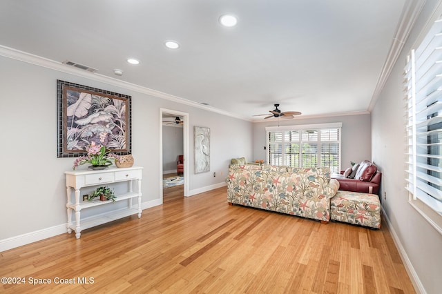 living room with light hardwood / wood-style flooring and ornamental molding