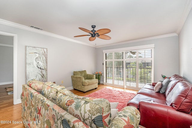 living room with light hardwood / wood-style floors, ceiling fan, and ornamental molding