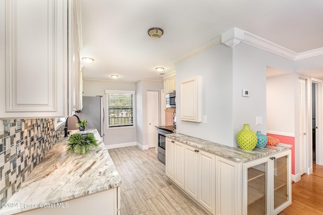 kitchen with light stone countertops, stainless steel appliances, crown molding, sink, and light hardwood / wood-style floors