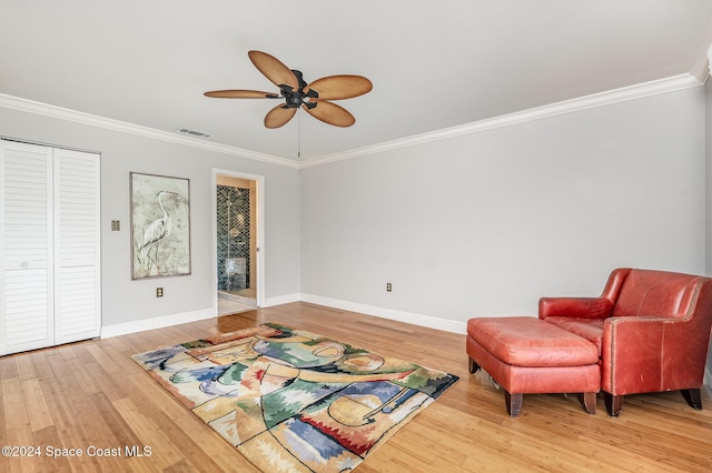 living area with ceiling fan, ornamental molding, and hardwood / wood-style flooring