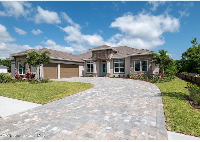 view of front facade with a garage and a front lawn