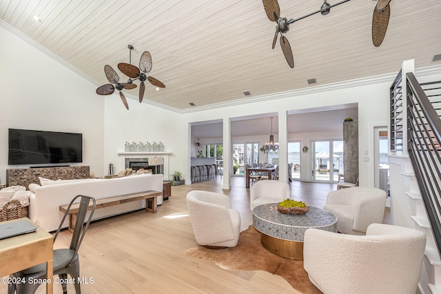 living room with ceiling fan with notable chandelier, light wood-type flooring, wooden ceiling, and lofted ceiling