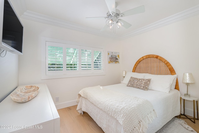 bedroom with light hardwood / wood-style flooring, ceiling fan, and crown molding