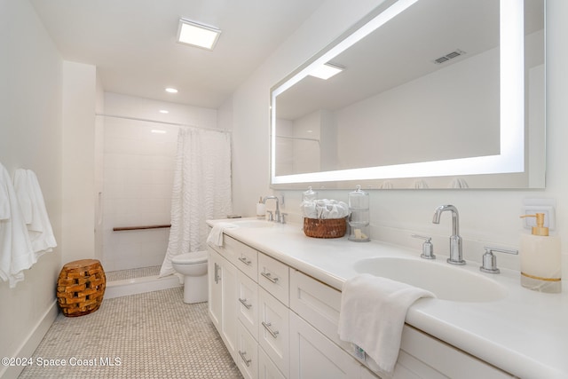 bathroom featuring tile patterned floors, vanity, toilet, and a shower with shower curtain