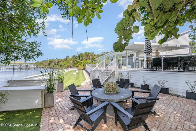 view of patio with a water view