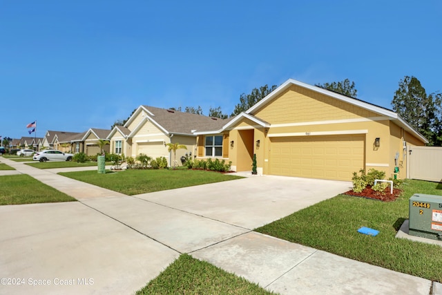 ranch-style house featuring a front yard and a garage