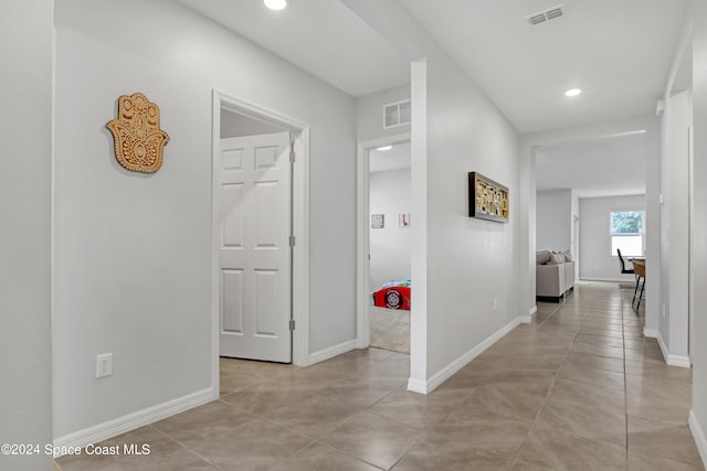 hall with light tile patterned flooring