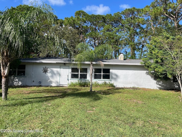 rear view of property with a yard