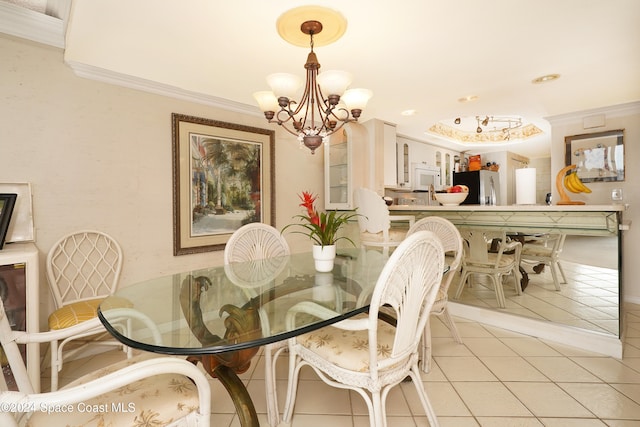 tiled dining space featuring a notable chandelier and ornamental molding