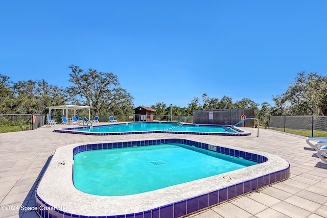 view of swimming pool featuring a patio area