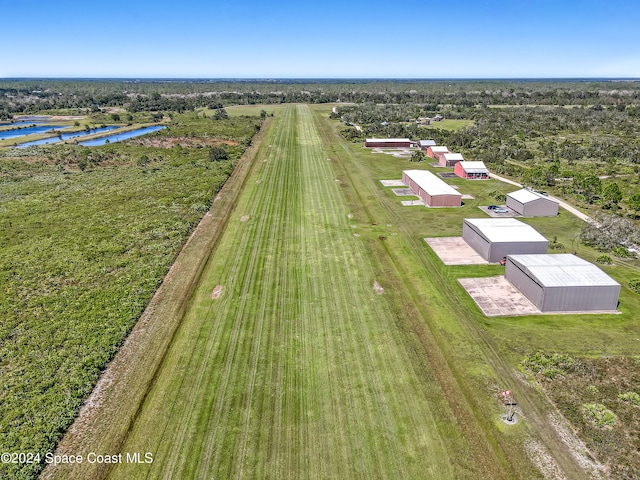 birds eye view of property with a water view and a rural view