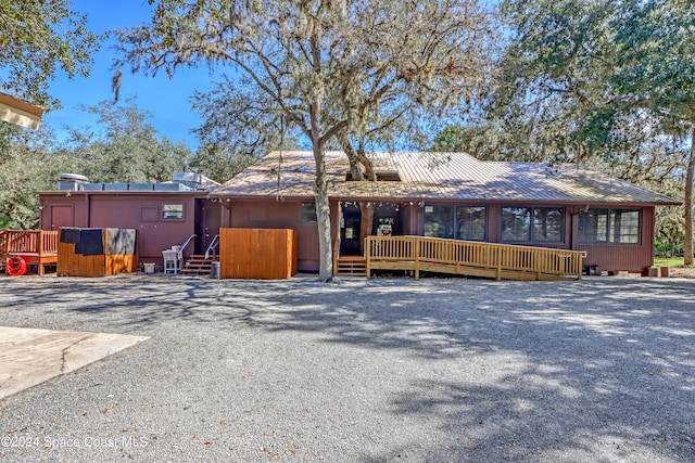 single story home featuring a wooden deck