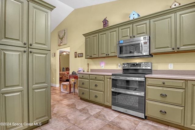 kitchen featuring ceiling fan, light tile patterned flooring, appliances with stainless steel finishes, and vaulted ceiling