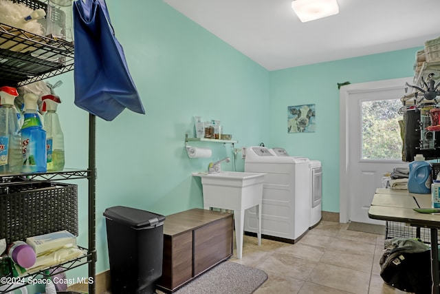 laundry room with washer and dryer and light tile patterned floors