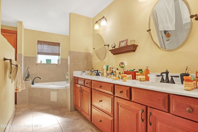 bathroom with vanity, tiled tub, and tile patterned flooring