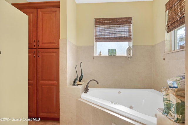 bathroom featuring tiled bath and tile walls