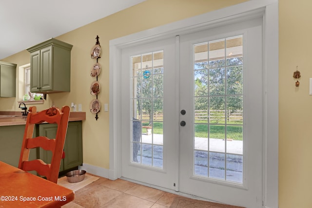 entryway featuring french doors and light tile patterned flooring