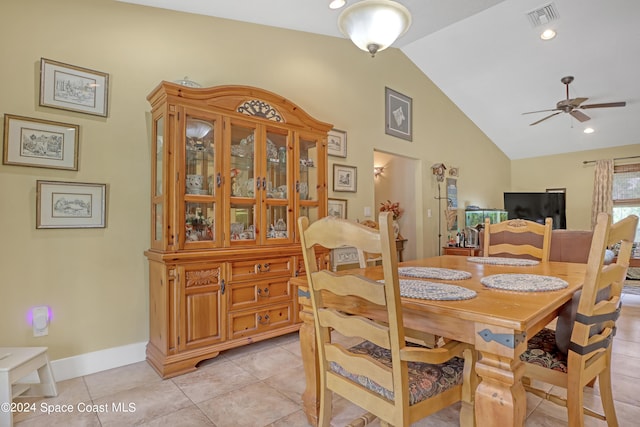 dining space featuring light tile patterned floors, lofted ceiling, and ceiling fan