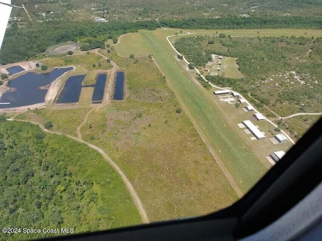 birds eye view of property with a water view and a rural view