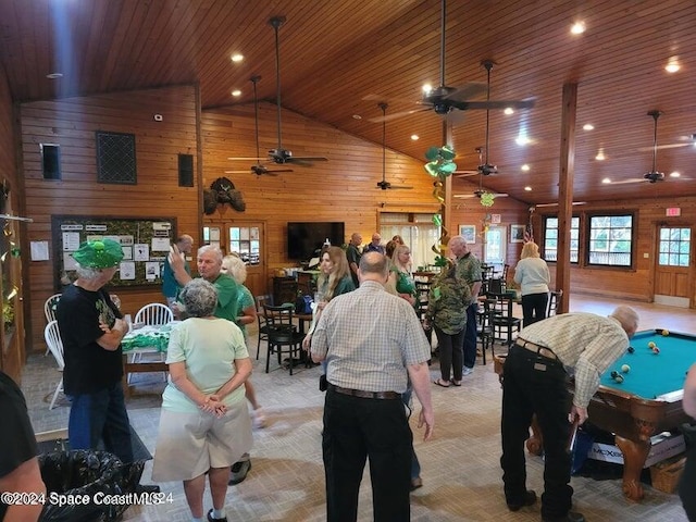 interior space with wooden walls, light colored carpet, high vaulted ceiling, and wooden ceiling